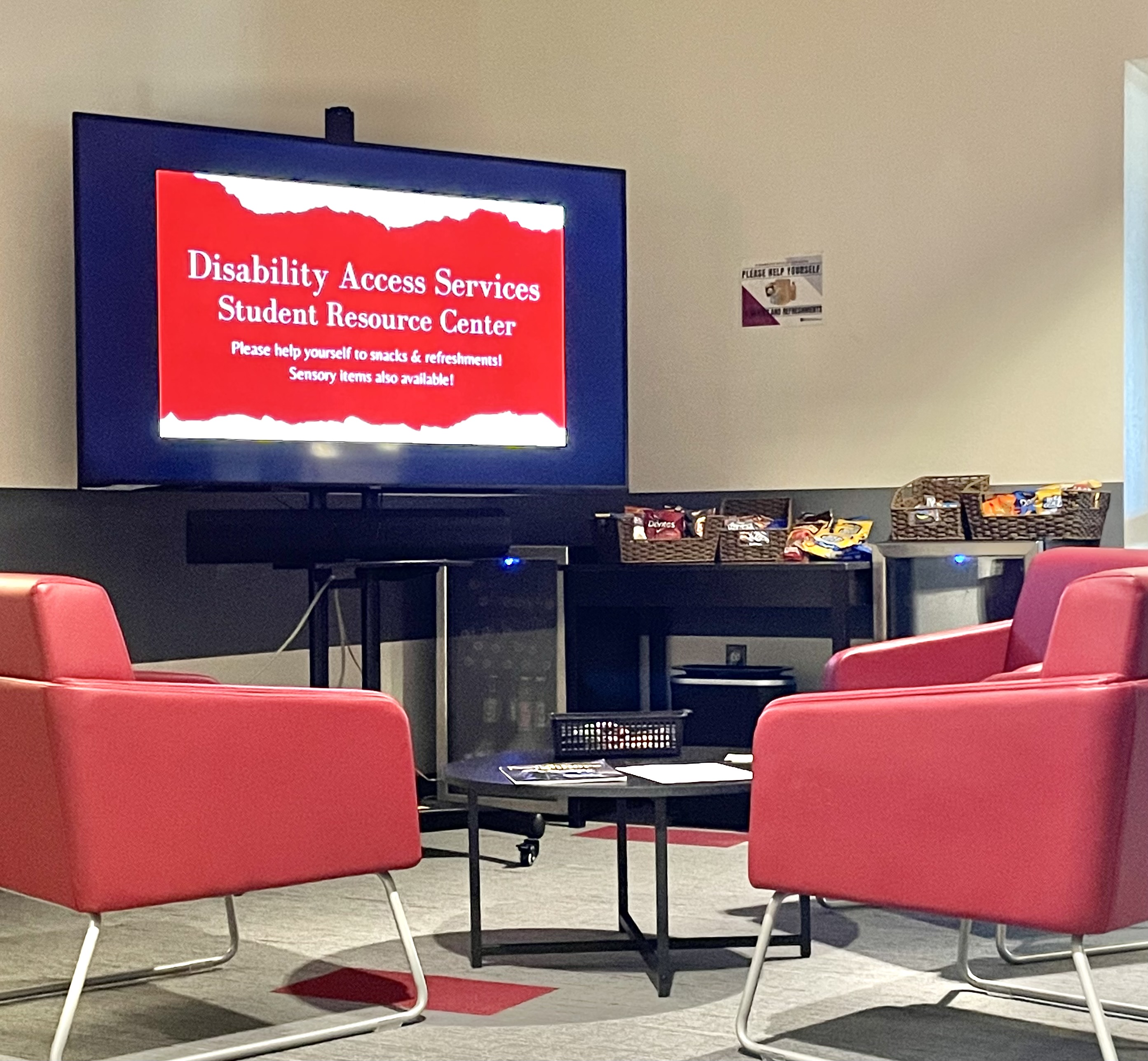 Resource Center with TV on screen that say, "DAS Resource Center" and chairs